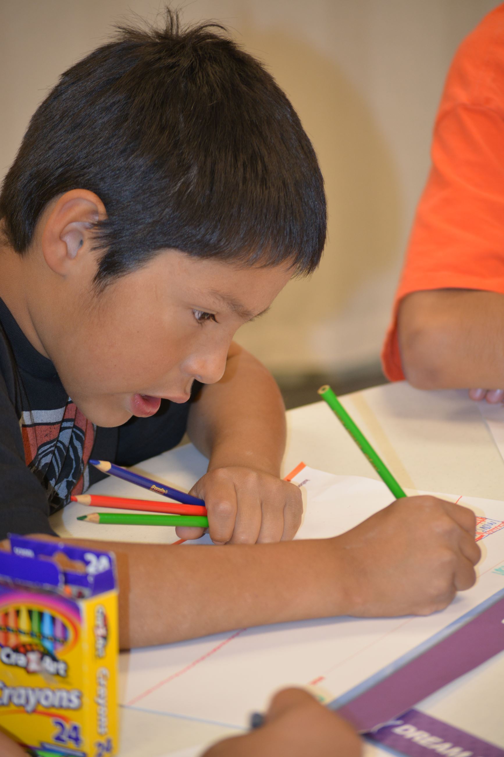 Boy Coloring at School
