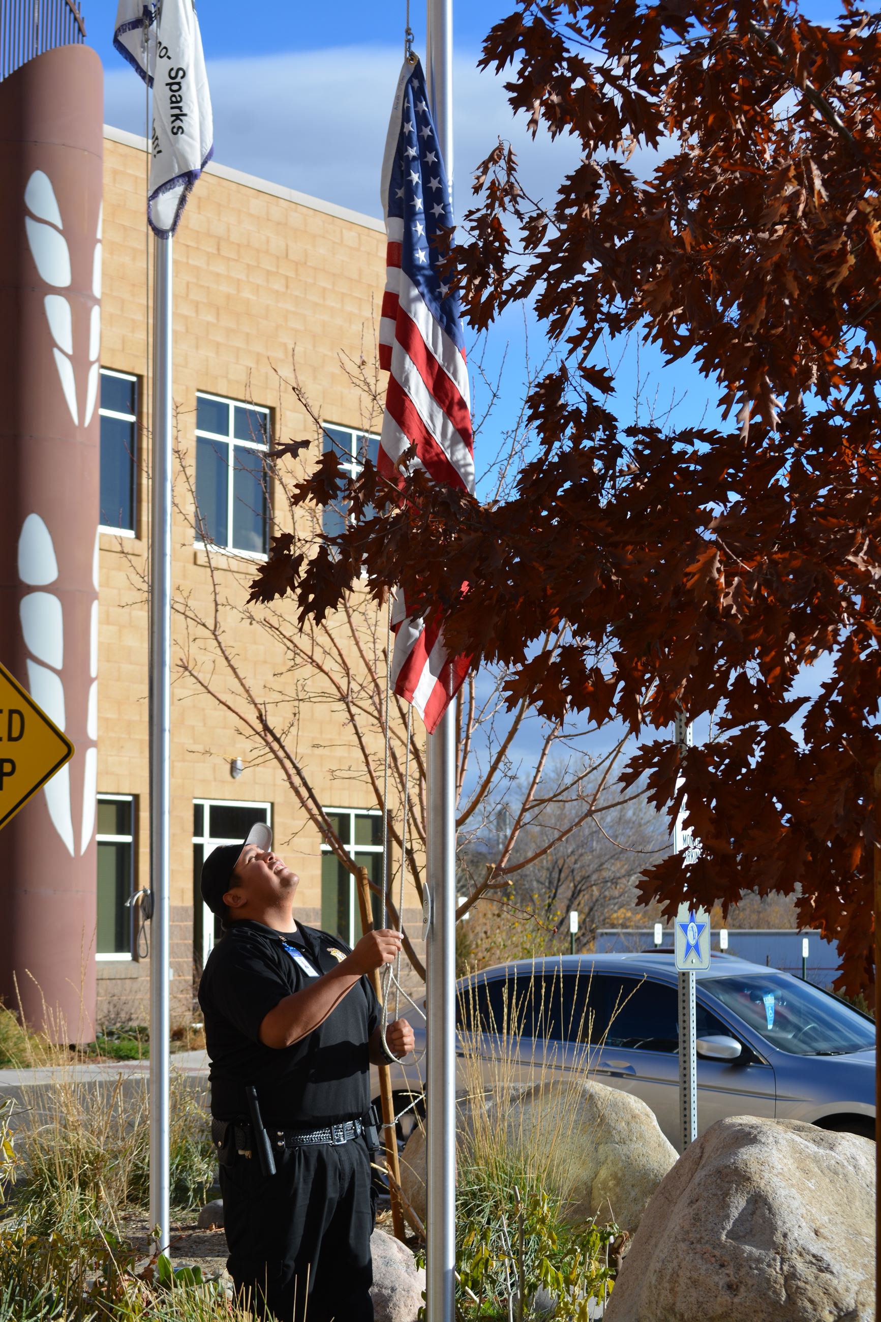 American Flag Being Raised in Front of the Health Center